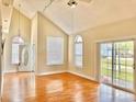 Bright living room featuring wood floors, high ceilings, large windows, and a sliding glass door to the outdoors at 829 9Th Ave. S, North Myrtle Beach, SC 29582