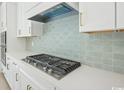Close-up of modern kitchen's stainless steel gas range and white cabinetry with sleek hardware at 1035 Milford Way, Myrtle Beach, SC 29588