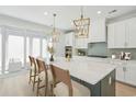 Modern kitchen featuring a large island with barstool seating and pendant lighting at 1035 Milford Way, Myrtle Beach, SC 29588