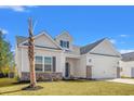 Beautiful home with a well-maintained lawn, a palm tree, and a two-car garage at 371 Lifestyle Court, Surfside Beach, SC 29575