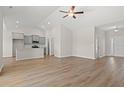 Open living room and kitchen with vaulted ceilings and luxury vinyl plank flooring at 371 Lifestyle Court, Surfside Beach, SC 29575