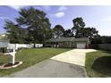 A single story home with a well-maintained lawn, a driveway and mature trees at 104 Sprucewood Ct., Myrtle Beach, SC 29588