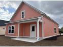 New home with a covered back patio and a freshly landscaped yard at 3131 Tiger Tail Rd., Conway, SC 29526