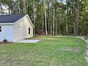 Spacious backyard with lush green grass and a detached structure, perfect for outdoor activities at 74 Greentown Rd., Georgetown, SC 29440