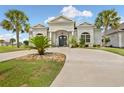 Beautiful home exterior features a circular driveway and lush tropical landscaping at 202 Ave. Of The Palms, Myrtle Beach, SC 29579