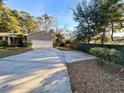 A large concrete driveway that provides ample parking space leading to a brick home with a two-car garage at 902 N 11Th Ave. N, North Myrtle Beach, SC 29582