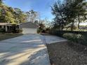 Home's exterior with a long driveway and wooden fence at 902 N 11Th Ave. N, North Myrtle Beach, SC 29582