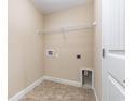 Functional laundry room with tiled floors, shelving, and essential hookups at 195 Leadoff Dr., Myrtle Beach, SC 29588