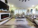 This staged living room has hardwood floors, two sofas, and an electric fireplace at 2000 Easy St., Conway, SC 29526