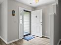 Inviting entryway featuring a white door, light gray walls, and durable wood-look flooring at 251 Galapagos Dr., Little River, SC 29566