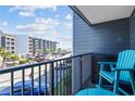 Balcony view of building parking lot, showing a blue outdoor chair and storage container at 5905 S Kings Hwy. # 231, Myrtle Beach, SC 29577