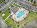 Aerial view of a community pool with lounge chairs and manicured landscaping at 5810 Longwood Dr. # 14-304, Murrells Inlet, SC 29576