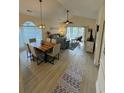 Open concept living area with vaulted ceiling, ceiling fan, modern lighting and sliding glass door at 674 Riverwalk Dr. # 301, Myrtle Beach, SC 29579