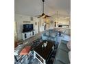 Bright open concept living area with vaulted ceilings, ceiling fan, tv and view to kitchen at 674 Riverwalk Dr. # 301, Myrtle Beach, SC 29579