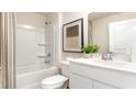 Bright bathroom features a white vanity, framed mirror, and a shower-tub combo for relaxation and convenience at 819 Buttonwood Dr., Conway, SC 29527