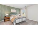 Inviting bedroom with anchor-themed wallpaper, soft carpet, and a comfortable bed perfect for relaxation at 819 Buttonwood Dr., Conway, SC 29527