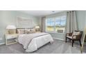 Cozy bedroom with neutral walls, plush carpet, and large window offering scenic views and natural light at 819 Buttonwood Dr., Conway, SC 29527