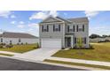 Beautiful home with well-kept lawn, two-car garage, and dark shutters at 128 Caveson Way, Conway, SC 29526