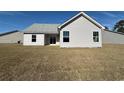 The home's backyard featuring white siding and complemented by large windows at 1248 Wehler Ct., Conway, SC 29526