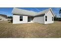 The backyard features light siding with a sliding glass door and two windows at 1248 Wehler Ct., Conway, SC 29526