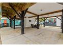 Spacious carport area featuring wood beams, concrete flooring, an outdoor seating area, and ample parking space at 6001 - N14 S Kings Hwy., Myrtle Beach, SC 29575