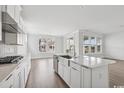 Modern kitchen featuring stainless steel appliances, light countertops, and an open floorplan at 512 9Th Ave. S, North Myrtle Beach, SC 29582