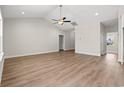 Open living area with wood flooring, a ceiling fan, and neutral-toned walls, offering a blank canvas for personalization at 6025 Flossie Rd., Conway, SC 29527