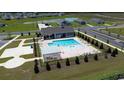 Aerial view of a sparkling community pool with lounge chairs, a pergola, and manicured landscaping at 197 Country Grove Way, Galivants Ferry, SC 29544