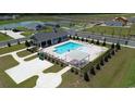 Aerial view of a sparkling community pool with lounge chairs, a pergola, and manicured landscaping at 197 Country Grove Way, Galivants Ferry, SC 29544