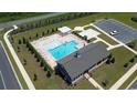 Aerial view of community pool featuring lounge chairs, pergola, clubhouse, and ample parking at 197 Country Grove Way, Galivants Ferry, SC 29544