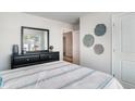 Bedroom with black dresser and striped bedding at 4573 East Coast Ln., Shallotte, NC 28470