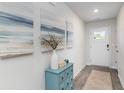 Inviting entryway featuring stylish decor, a charming blue accent table, and a decorative rug at 4573 East Coast Ln., Shallotte, NC 28470