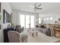 Open-concept living room with neutral tones, comfortable seating, and sliding doors to the outdoors at 512 9Th Ave. S, North Myrtle Beach, SC 29582