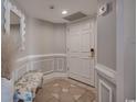Entryway boasts elegant molding, tiled floor, and a decorative mirror for a sophisticated welcome at 9650 Shore Dr. # 1805, Myrtle Beach, SC 29572