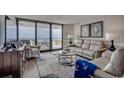 Living room featuring comfortable seating, ocean views, and access to a private balcony at 9650 Shore Dr. # 1805, Myrtle Beach, SC 29572