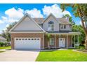Beautiful two-story home with a brick and siding exterior, a two-car garage, and a well-maintained front lawn at 629 Slash Pine Ct., Myrtle Beach, SC 29579