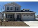 Attractive two-story home with stone accents, a covered porch and a two-car garage at 895 Agostino Dr., Myrtle Beach, SC 29579