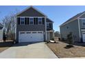 Charming two-story home with a gray exterior, black shutters, and a two-car garage with concrete driveway at 1055 Oak Meadow Dr., Conway, SC 29526