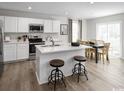 Modern kitchen with white cabinets, stainless steel appliances, a kitchen island, and hardwood floors at 1055 Oak Meadow Dr., Conway, SC 29526