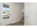 Bright entryway featuring a glass front door, wood floors, and a staircase at 748 Rupert Dr, Conway, SC 29526