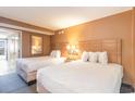 Comfortable bedroom with two beds, soft lighting, and a view of the balcony at 1501 South Ocean Blvd. # 644, Myrtle Beach, SC 29577