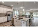 Open concept kitchen with island, stainless steel appliances, and view into living room at 203 Portofino Dr., Myrtle Beach, SC 29579