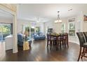 Inviting living area with hardwood floors, comfortable seating, and natural light from sliding glass doors at 1100 Commons Blvd. # 104, Myrtle Beach, SC 29572