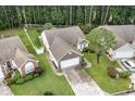 Overhead shot of a well-maintained home with driveway, manicured lawns, and mature trees at 376 Mckendree Ln., Myrtle Beach, SC 29579
