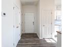 Bright entryway boasts wood-look flooring, white walls, and multiple storage closets upon entry at 2060 Cross Gate Blvd. # 305, Surfside Beach, SC 29575