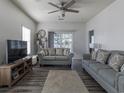 Relaxing living room with plush sofas, ceiling fan, and natural light from the sliding glass door at 2060 Cross Gate Blvd. # 305, Surfside Beach, SC 29575