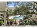 Beautiful community pool surrounded by trees and lush landscaping at 2805 N Ocean Blvd. # 214, Myrtle Beach, SC 29577