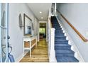 Bright foyer with wood flooring, stairwell, and coastal-themed decorations at 4808 Cantor Ct., North Myrtle Beach, SC 29582