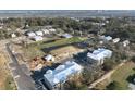 Aerial view of a new home development with various buildings and a pond at 110 Hallandale Lane, Murrells Inlet, SC 29576