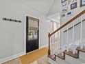 Bright entryway with a black door, stairs, and wood flooring at 118 Sly Fox Trail, Myrtle Beach, SC 29588